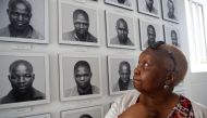 Pulane Koboekae looks at a picture of her older brother Richard Motsoahae during a tour of the gallows at Kgosi Mampuru Correctional Facility in Pretoria, South Africa on August 15, 2018. AFP / Phill Magakoe 

