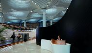 A receptionist waits for passengers at the entrance of Turkish Airlines business class check-in hall at the city’s new Istanbul Airport in Istanbul, Turkey.