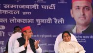 Indian Samajwadi Party (SP) president Akhilesh Yadav (L) and Bahujan Samaj Party (BSP) president Mayawati (R) applaud and laugh at the SP-BSP-RLD alliance's first joint rally in Deoband in Uttar Pradesh state on April 7, 2019. AFP / Sanjay Kanojia
