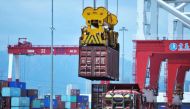 A container is transferred at a port in Qingdao, Shandong province in eastern  China on July 6, 2018.  AFP