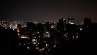 (FILES) This file photo taken on March 26, 2019, shows a general view of Altamira neighborhood partially illuminated during a power outage in Caracas, Venezuela. AFP / FEDERICO PARRA