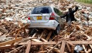 FILE PHOTO: A man gestures next to his car after it was swept into debris left by Cyclone Idai in Chimanimani, Zimbabwe, March 23, 2019. REUTERS/Philimon Bulawayo