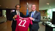 Qatar Football Association (QFA) President Sheikh Hamad bin Khalifa bin Ahmed Al Thani handing over a Qatar football jersey to the newly elected Brazil Football Association (CBF) President, Rogerio Caboclo during a meeting held in Rio de Janeiro, yesterda