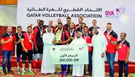 The players and officials of Al Rayyan pose for a picture during the victory ceremony, after winning the Qatar Cup in Doha yesterday.