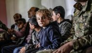 Iraqi Yazidi children rescued from the Islamic State (IS) group waiting to board buses bound for Sinjar in Iraq's Yazidi heartland. AFP / Delil SOULEIMAN
