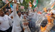 Activists of Delhi Pradesh Youth Congress burn cut-outs of India's Prime Minister Narendra Modi and Chief of India's ruling Bharatiya Janata Party (BJP) Amit Shah during a protest against what they say are politically motivated raids by Income Tax officia