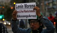 A man holds a placard against Ecuadoran President Lenin Moreno as he demonstrates against the arrest of WikiLeaks founder Julian Assange in front of the Foreign Ministry in Quito on April 11, 2019. AFP / Cristina VEGA