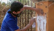 A Nicaraguan anti-government protester paints a graffiti in Managua on April 13, 2019 ahead of the first anniversary of protests movement against President Daniel Ortega.  AFP / Inti Ocon 