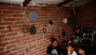 Arturo, 33, a Mexican migrant, who was denied a visa to the United States, smiles next his sons Juan , 10 and Javen, 6, as they eat breakfast inside their house in Neutla, Guanajuato state, Mexico, April 9, 2019. Picture taken April 9, 2019. Reuters/Edgar