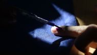 In this file photo taken on April 18, 2019 an Indian voter gets his finger marked with ink as he votes at a polling station in Chennai, during the second phase of the mammoth Indian elections. / AFP / ARUN SANKAR 