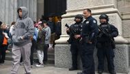 Members of the New York Police Department gather outside St. Patrick's Cathedral on 5th Avenue April 18, 2019, the morning after a man was arrested after trying to enter the Cathedral with gas cans. AFP / Timothy A Clary 