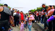 Cuban migrants stand along a road after their buses were seized by Mexican authorities as they participate in the Migrant Via Crucis to continue in their journey towards the United States, in Huixtla, April 17, 2019. Reuters/Jose Cabezas