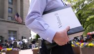 A reporter departs with his official copy of Special Counsel Robert Mueller's report on Russian interference in the 2016 U.S. presidential election, outside the Department of Justice in Washington, U.S., April 18, 2019. Reuters/Jonathan Ernst