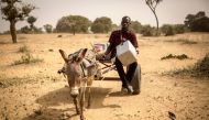 Mamadou Kassé, a vaccinator at the Sofara community health center, travels by donkey cart with vaccines to reach Kankelena village in Mopti region, Mali, March 15, 2019. UNICEF handout via Thomson Reuters Foundation 