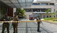 Sri Lankan security personnel stand guard at the cordoned off entrance to the luxury Shangri-La Hotel in Colombo on April 21, 2019 following an explosion.  AFP / ISHARA S. KODIKARA