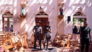 Sri Lankan soldiers look on inside the St Sebastian's Church at Katuwapitiya in Negombo on April 21, 2019, following a bomb blast during the Easter service that killed tens of people. AFP