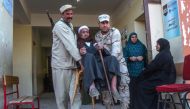 Egyptian soldiers carry an elderly man at a polling station in a referendum on constitutional amendments, at a school in al-Ayat village, 90 km south of Cairo, on the first day of a three-day poll, on April 20, 2019. AFP
