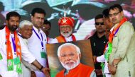 Indian Prime Minister Narendra Modi (C) holds a canvas displaying a portrait of himself during his election rally in Chittorgarh, in the western state of Rajasthan, on April 21, 2019. / AFP / Himanshu Sharma