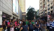 People gather outside a shopping mall after a powerful earthquake rocked Manila on April 22, 2019.  AFP / Ted ALJIBE