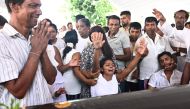 Relatives mourn beside a coffin of a bomb blast victim during a funeral service at St Sebastian's Church in Negombo on April 23, 2019, two days after a series of bomb attacks targeting churches and luxury hotels in Sri Lanka. AFP / Jewel SAMAD