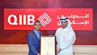 QIIB Deputy CEO, Jamal Abdullah Al Jamal (right), receiving the certificate at a ceremony held at the Bank’s headquarters in Grand Hamad Street, yesterday.
