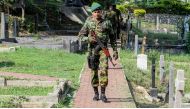A Sri Lankan soldier stands guard during a burial ceremony for bomb blast victims at a cemetery in Colombo, Sri Lanka on April 24, 2019. ( Chamila Karunarathne - Anadolu Agency )