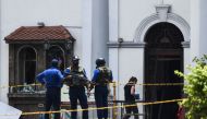 A foreign investigator (R) walks into St. Anthony's Shrine as soldiers stand guard in Colombo on April 25, 2019, following a series of bomb blasts targeting churches and luxury hotels on the Easter Sunday in Sri Lanka. AFP / Jewel Samad