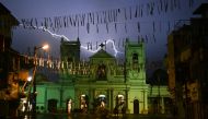 Lightning strike in the sky over St. Anthony's Shrine in Colombo on April 25, 2019, as soldiers stand guard following a series of bomb blasts targeting churches and luxury hotels on the Easter Sunday in Sri Lanka.  AFP / Jewel Samad
 