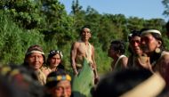 Waorani indigenous people sail in a canoe in the Curaray river, near the village of Nemompare, in Pastaza province, Ecuador on April 14, 2019.  / AFP / RODRIGO BUENDIA 