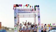 Qatar’s Nasser Saleh Al Attiyah and his French co-driver Matthieu Baumel celebrate with podium winners and officials after winning the Jordan Rally, yesterday.