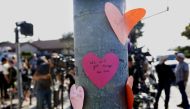  Hand-written notes are displayed on a light post across the street from the Chabad of Poway Synagogue after a shooting on April 27, 2019 in Poway, California. AFP / Sandy Huffaker
 