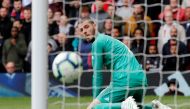 Chelsea's Marcos Alonso scores their first goal as Manchester United's David de Gea looks on REUTERS/Phil Noble 