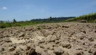 Cracked soil waits for rain at Tapan Mondal’s fields, in Chouldari, India, March 6, 2019. Thomson Reuters Foundation/Colin Daileda 