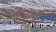 In this photograph taken on September 29, 2015, Pakistani tourists leave the Pakistan-China Khunjerab Pass, the world's highest paved border crossing at 4,600 metres above sea level. AFP / Aamir Qureshi
