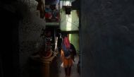 A woman walks through an alley in a residential area in New Delhi, India, April 30, 2019. Reuters/Anushree Fadnavis