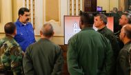 Handout photo released by the Venezuelan Presidency of Venezuela's President Nicolas Maduro (L) accompanied by military commanders and members of his cabinet at the Miraflores presidential palace in Caracas, on April 30, 2019. AFP PHOTO / VENEZUELAN PRESI