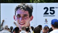 People sign a giant placard bearing a portrait of Brazilian's F1 driver Ayrton Senna on the 