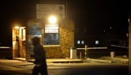 In this file photograph taken on April 24, 2014, a pedestrian walks by the community centre at the Chris Hani Baragwanath Hospital in the South African landmark township of Soweto. AFP/Mujahid Safodien