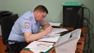 An official of a migration department under Russia's Interior Ministry receives and registers passport applications of Ukrainian separatist-controlled Donetsk and Luhansk Regions' residents, after Russia's President Vladimir Putin signed an order simplify