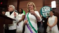 U.S. Rep. Carolyn Maloney (D-NY) (C) holds a thumbs up as National Organization for Women President Toni Van Pelt (L), President and co-founder of the Feminist Majority Foundation Eleanor Smeal (2nd L), and Actress Alyssa Milano (R) attend a news conferen