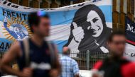 Supporters of Cristina Fernandez de Kirchner stand in front of a banner with her image as they wait for her to leave court in Buenos Aires, October 31, 2016. Reuters/Marcos Brindicci