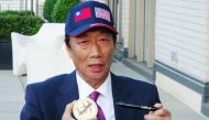 This CNA handout picture released on May 2, 2019 show Foxconn Chairman Terry Gou displaying a US president's signature outside the White House in Washington after meeting with US President Donald Trump. AFP PHOTO / CNA PHOTO