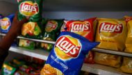 A customer picks packets of Lay's potato chips at a shop in Ahmedabad, India, April 26, 2019. REUTERS/Amit Dave