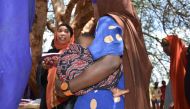 Alima Hossain, wearing a beaded solar-powered GPS bracelet, waits for her turn for health check-up in Yaballo Godha, Moyale, Kenya, April 8, 2019. Thomson Reuters Foundation/Munyaradzi Makoni
