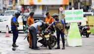 Sri Lankan Navy personnel inspect a motorcycle as they block a road at the harbour in Colombo on May 3, 2019, after a series of bomb blasts targeting churches and luxury hotels on Easter Sunday in Sri Lanka. AFP / Ishara S. Kodikara 