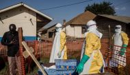 A family member of a deceased unconfirmed Ebola patient reacts inside an Ebola Treatment Centre run by The Alliance for International Medical Action on August 13, 2018 in Beni. AFP/John Wessels