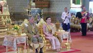  This framegrab handout from the Thai Royal Household Bureau taken and released on May 4, 2019 shows Thailand's King Maha Vajiralongkorn sitting beside Queen Suthida during his coronation in Bangkok. AFP PHOTO / THAI ROYAL HOUSEHOLD BUREAU