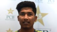 Pakistani right-arm fast bowler Mohammad Hasnain speaks to journalists at the Gaddafi Cricket Stadium in Lahore. (AFP / ARIF ALI)