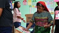 A Kuna indigenous woman casts her vote at a polling station during presidential and parliamentary elections in Kuna Negra municipality, Panama City on May 5, 2019.  AFP / Luis Acosta