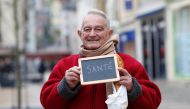 Representative image: (Francois Dore, 83,  holds a blackboard with the word health the most important election issue for him as he poses for Reuters in Chartres, France,  February 1, 2017.)  